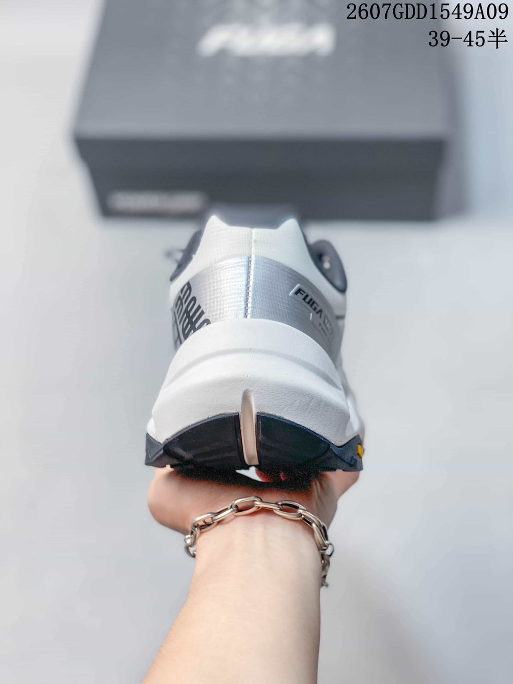 Rear view of the shoe showing the padded heel structure, white midsole and dark outsole sections.