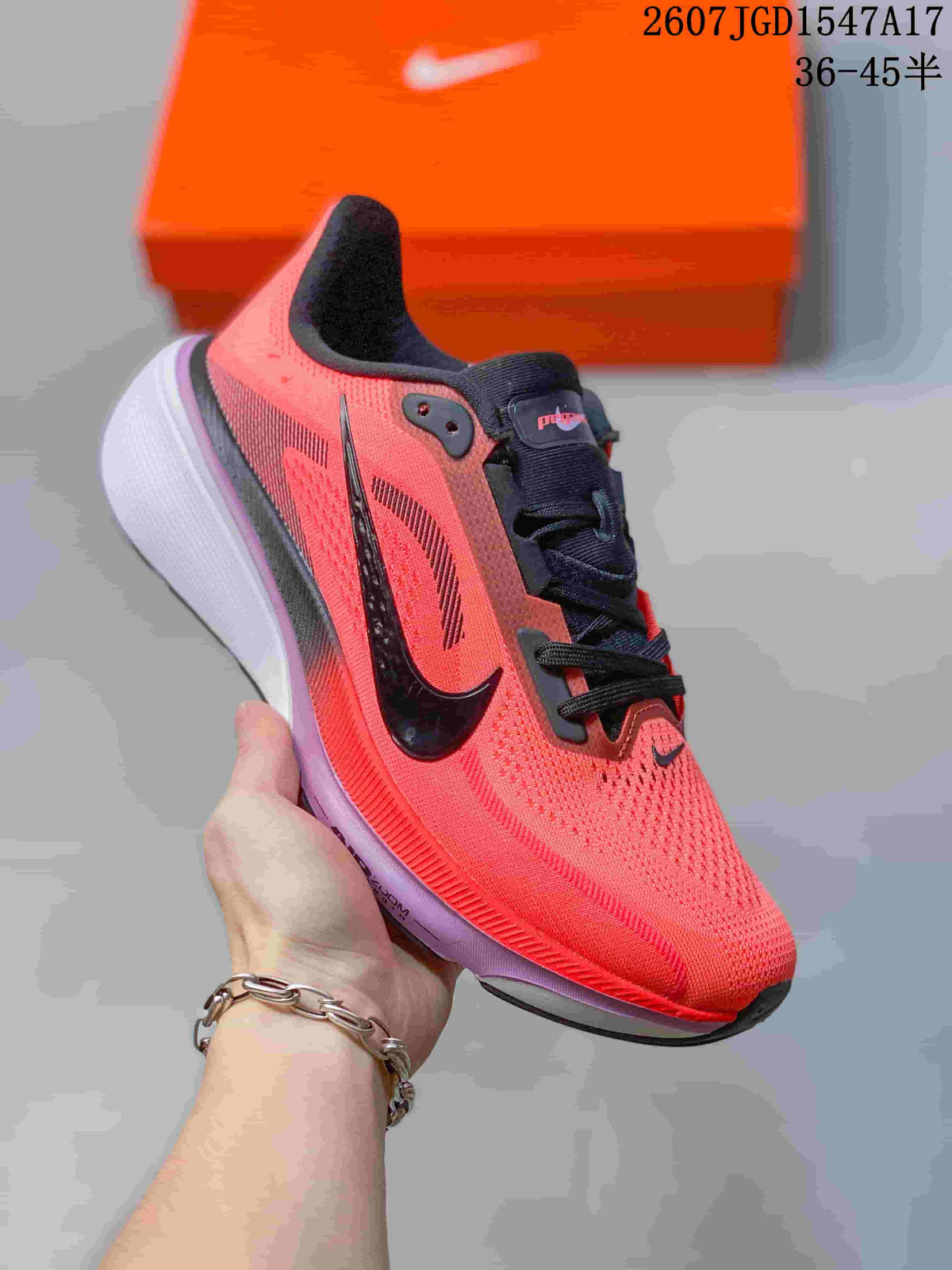 Coral and black Nike Air Zoom Pegasus 42 running shoe with a pale purple outsole.