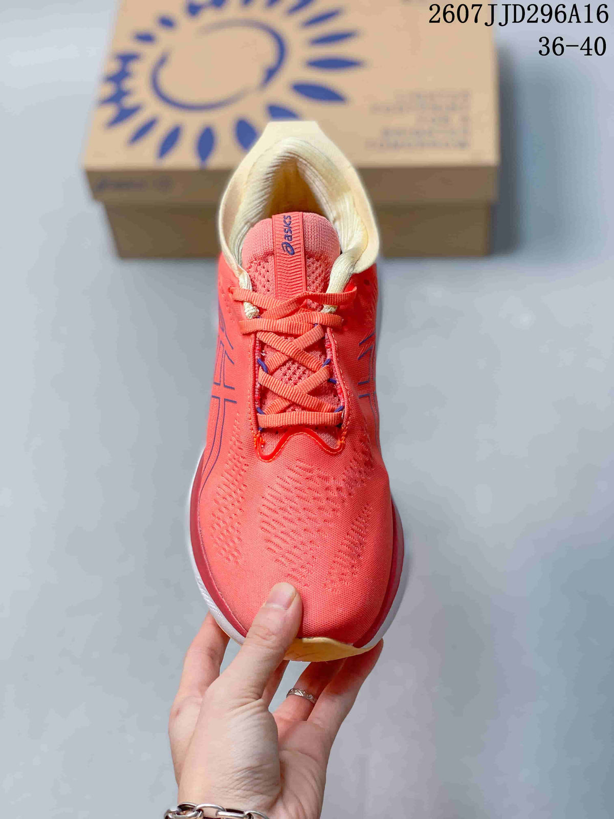Top view of the coral pink lace-up running shoe showing the textured upper, tongue and cream padded collar.