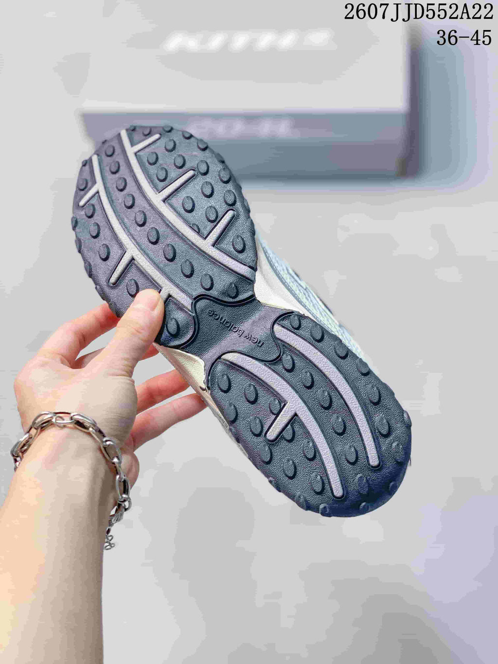 Close-up of the black textured outsole with segmented tread and raised circular traction details.