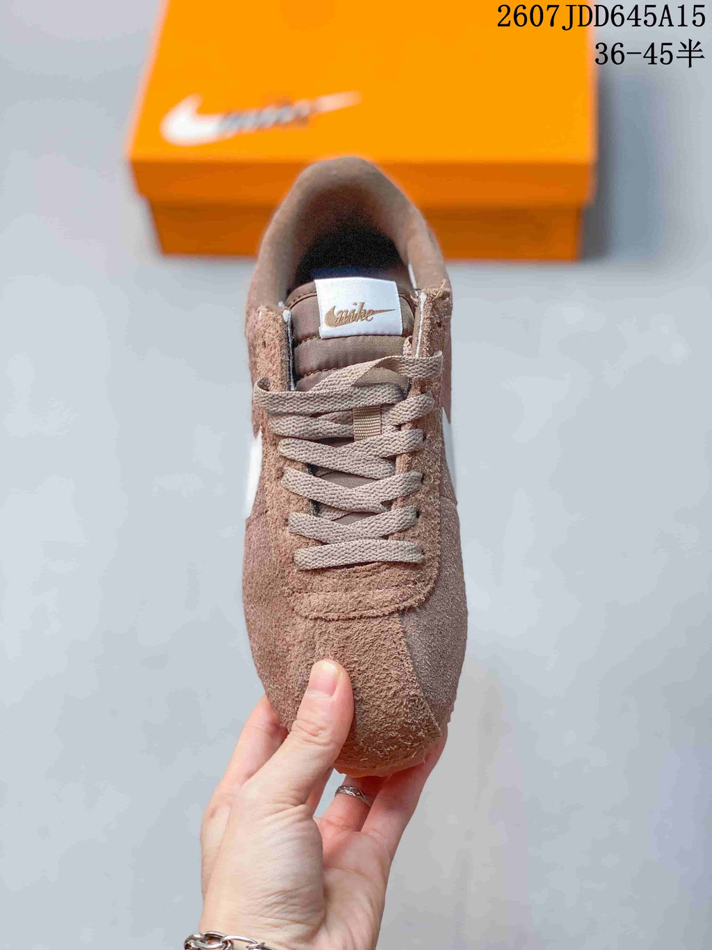 Top view of the brown lace-up sneaker showing the padded tongue, laces, and textured upper.