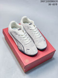 Pair of white Puma low-top sneakers displayed on a red Puma shoebox.
