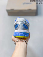 Rear view of the sneaker showing the blue heel panel, white upper and lime outsole edge.