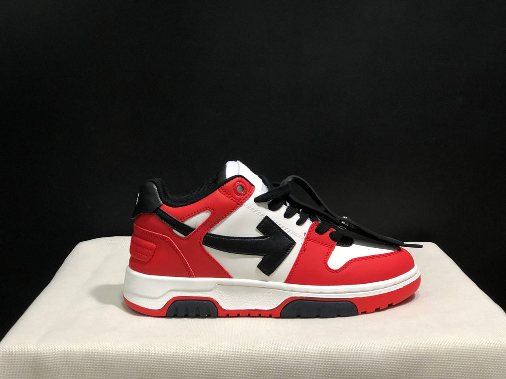 Close side view highlighting the red and white upper, black side arrow panel, black laces, and rubber outsole.