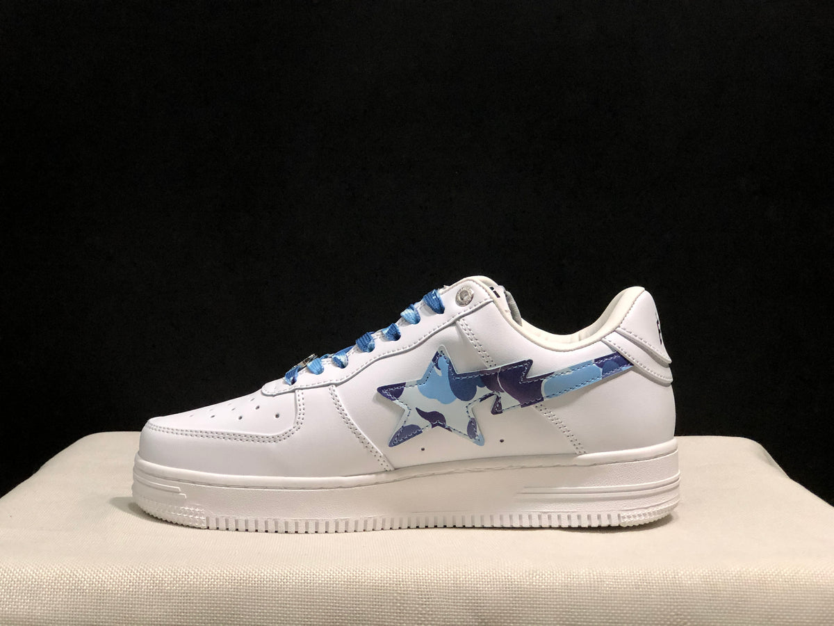 Side profile highlighting the white low-top construction, blue camouflage star detail, and textured outsole.