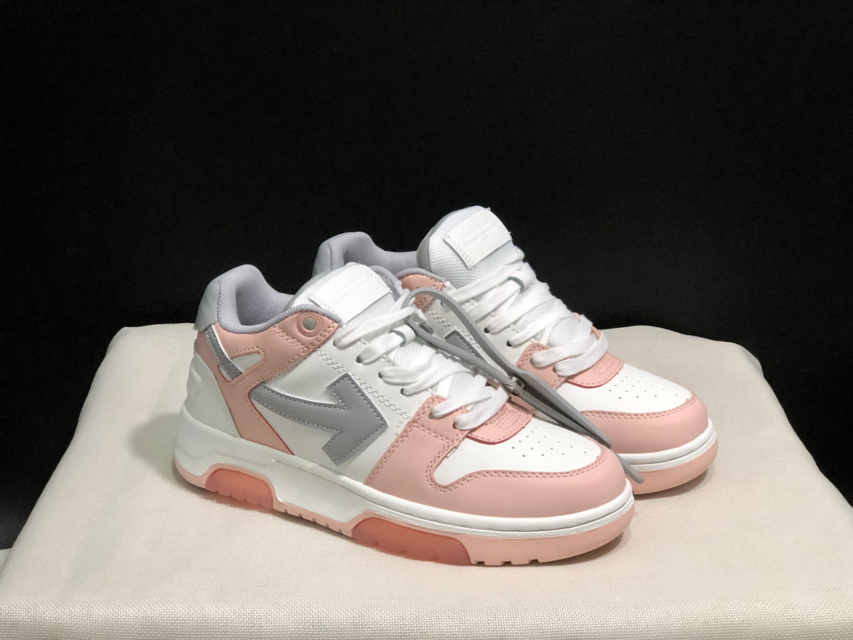 Three-quarter view of the white, pink and grey sneaker pair with attached tag detail visible.