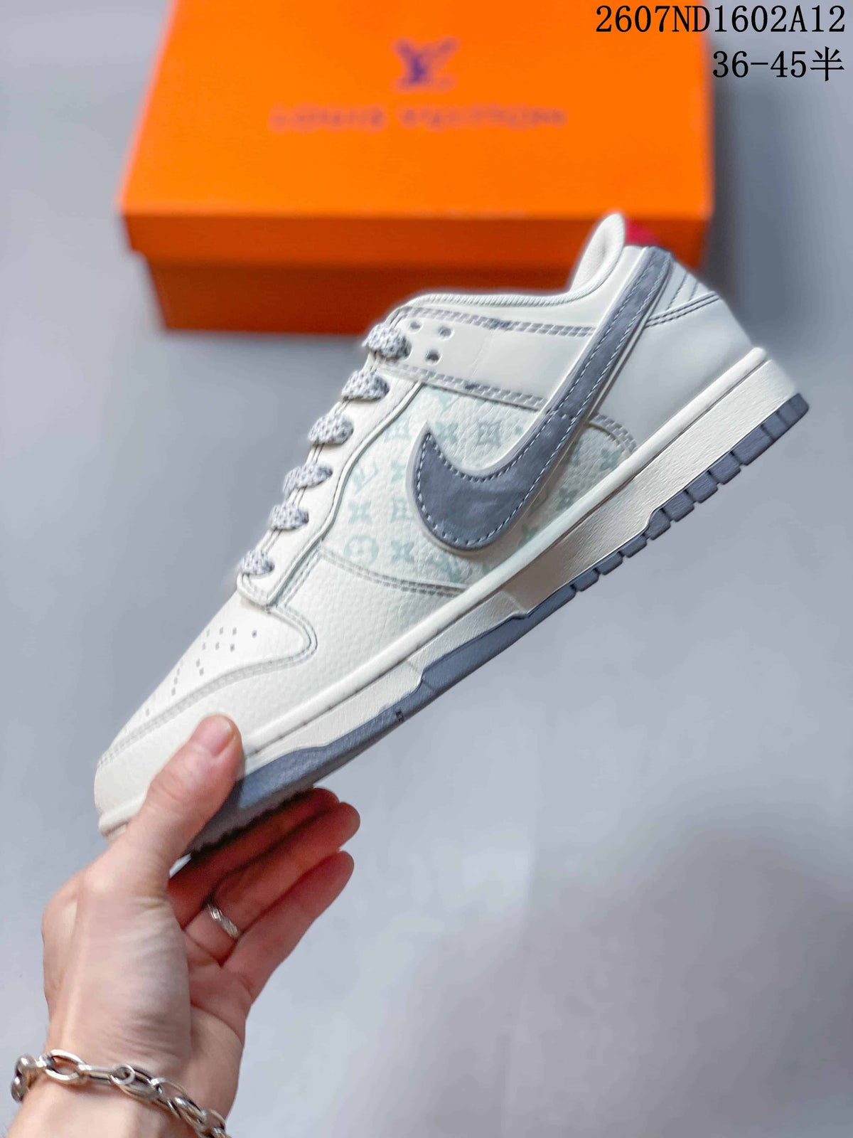 Side profile showing the white upper, gray patterned panel, gray Swoosh, white midsole, and gray outsole.
