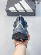 Rear view showing the heel and outsole of a dark gray Adidas shoe