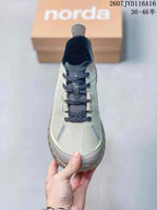 Top view showing the lace-up construction, dark laces, mesh-like upper panels, and contrasting toe details.