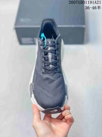 Top view of the sneaker showing the rounded mesh toe, lace system, and contrasting turquoise lace accent.