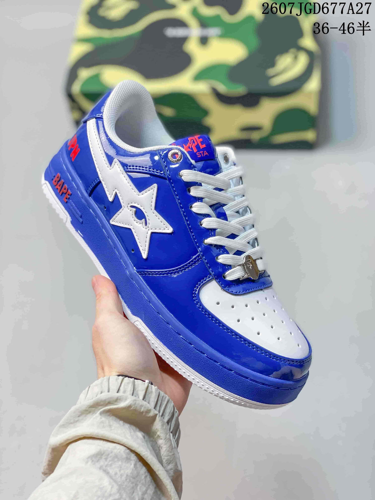 Angled side view of a blue and white BAPE STA low-top sneaker with a white star logo, blue patent-style panels, and white outsole.