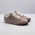 Pair of pink and white low-top sneakers shown from a three-quarter front angle.