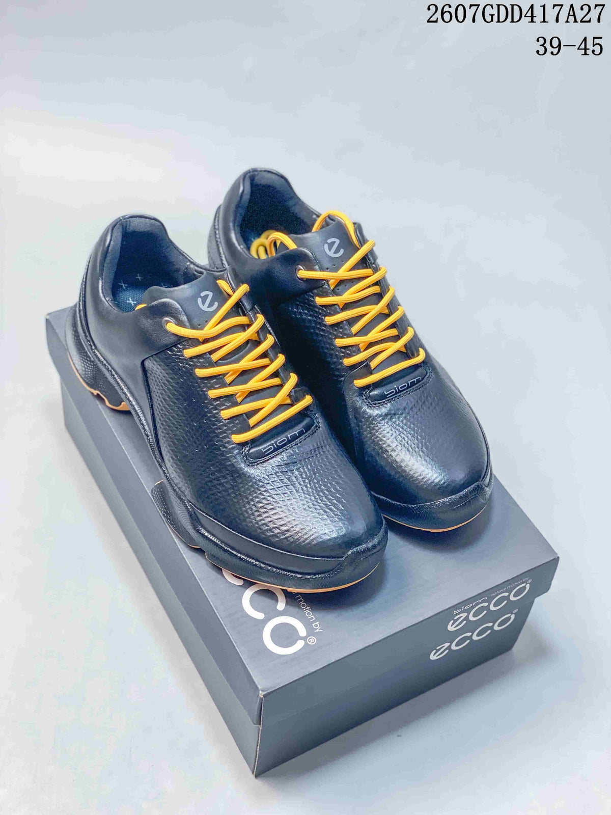 Pair of black ECCO BIOM lace-up sneakers with yellow laces displayed on an ECCO shoe box.