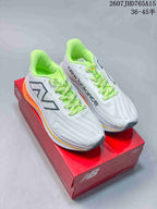 Pair of white New Balance RC Elite running shoes with lime-green accents displayed on a red shoebox.