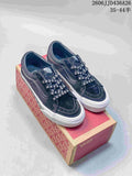 Pair of black Vans SK8-Low sneakers with skull-print laces displayed on a Vans shoe box.