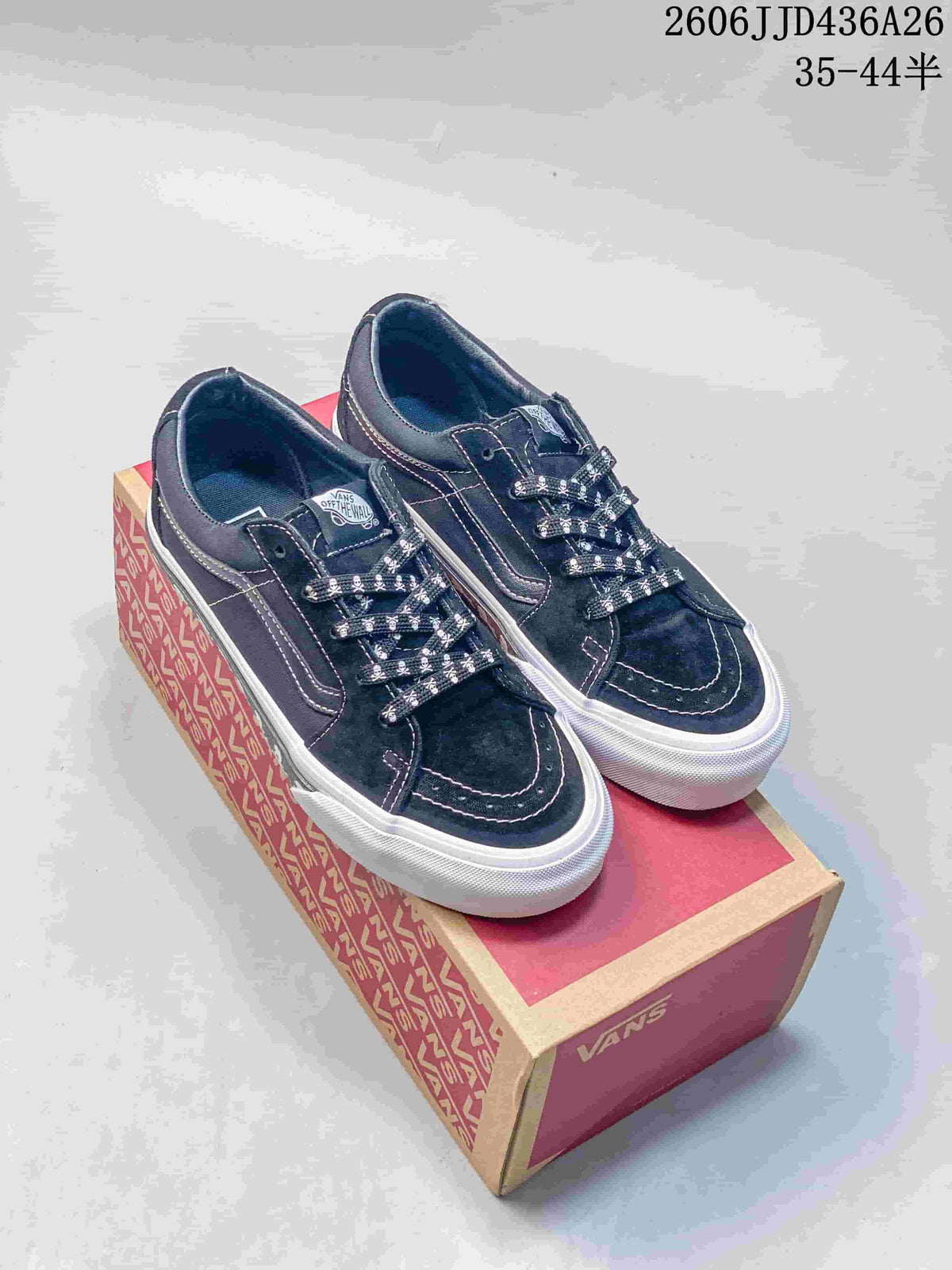 Pair of black Vans SK8-Low sneakers with skull-print laces displayed on a Vans shoe box.