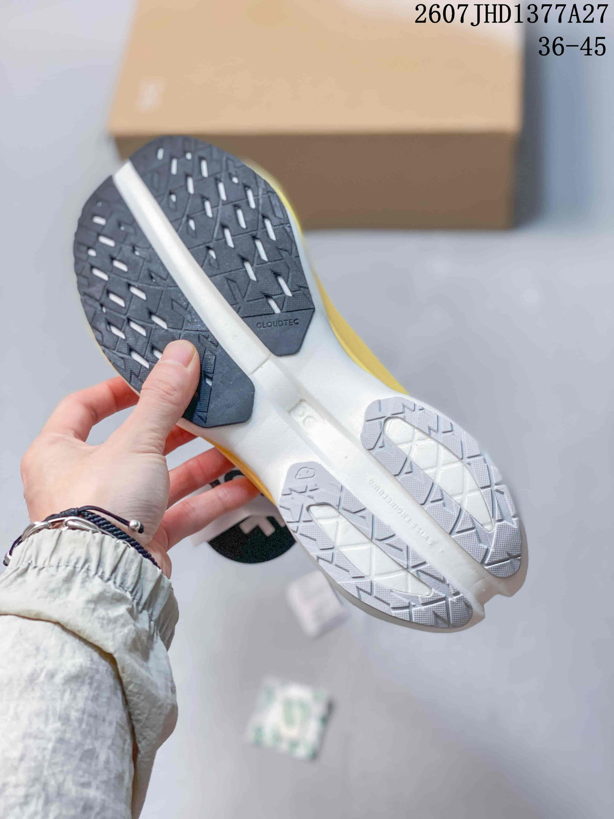 Underside view of the sneaker showing the black and white patterned outsole with CloudTec marking; the image shows the printed range 36–45 and style code JHD1377A27.