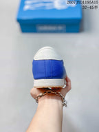 Rear view of the blue sneaker showing the white heel tab, blue heel panel and cream midsole.