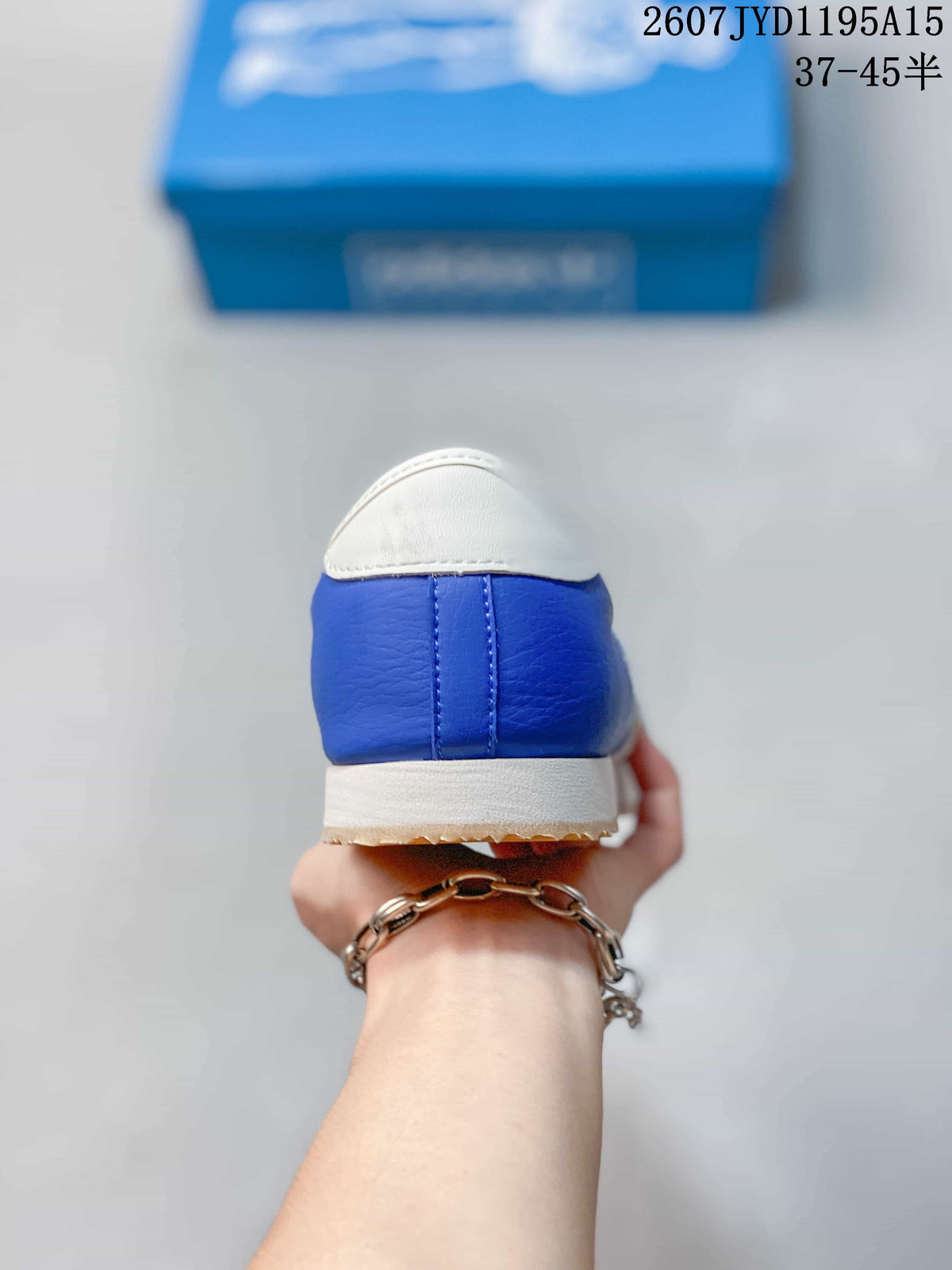 Rear view of the blue sneaker showing the white heel tab, blue heel panel and cream midsole.