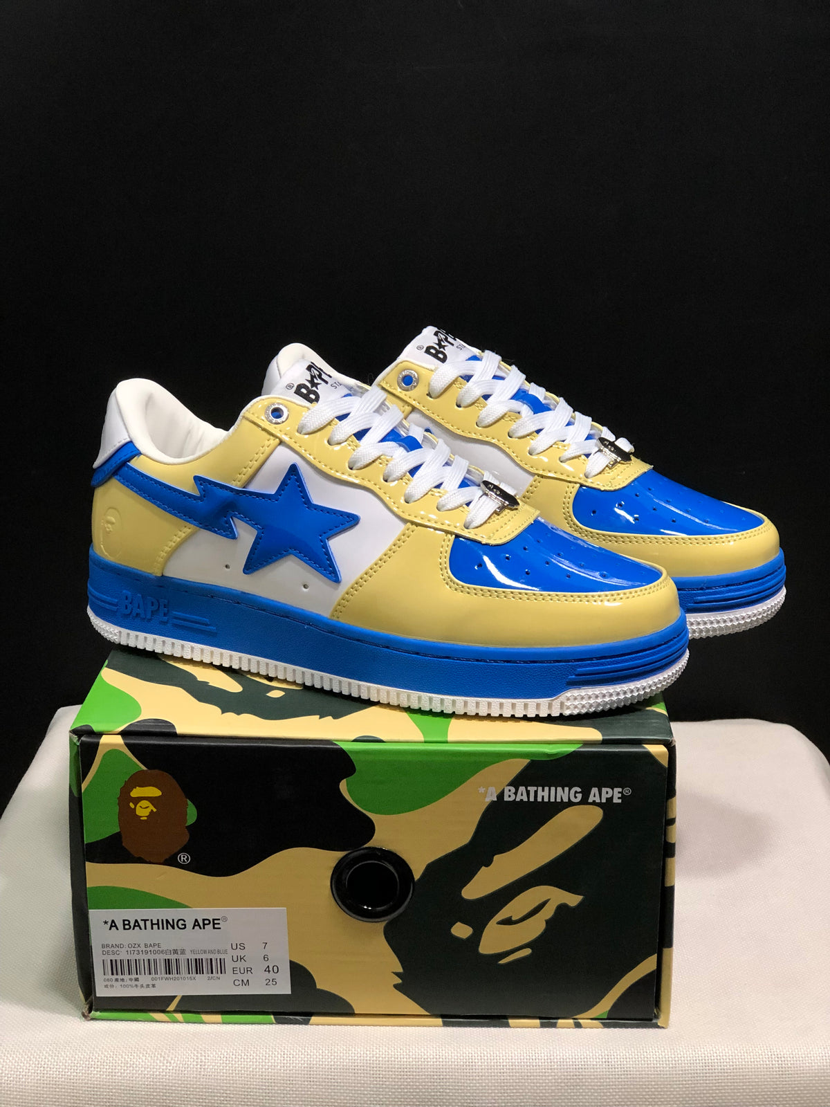 Blue and yellow BAPE STA sneakers displayed on a branded shoe box