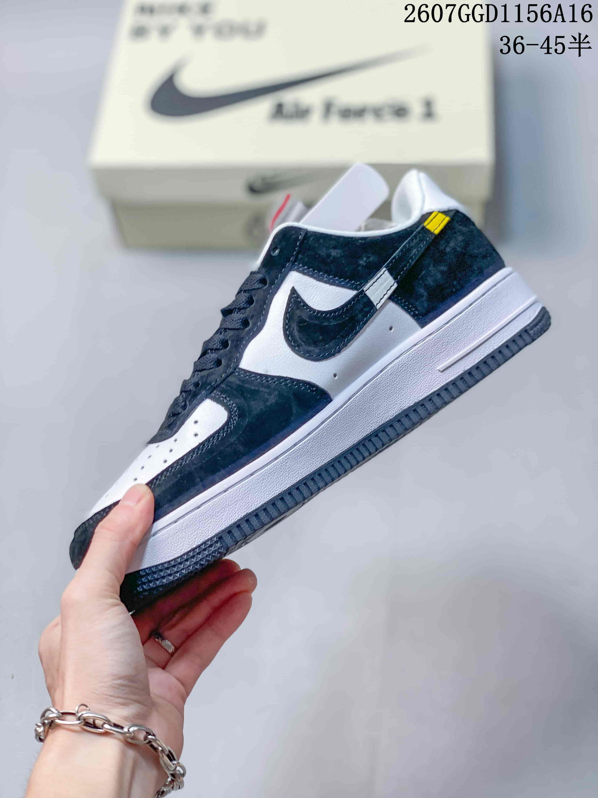 Side view of the black and white sneaker showing the layered Swoosh, contrasting panels, white midsole, and dark outsole.
