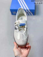 Top view of the white sneaker showing the Mary Jane-style strap, laces and textured toe panel.