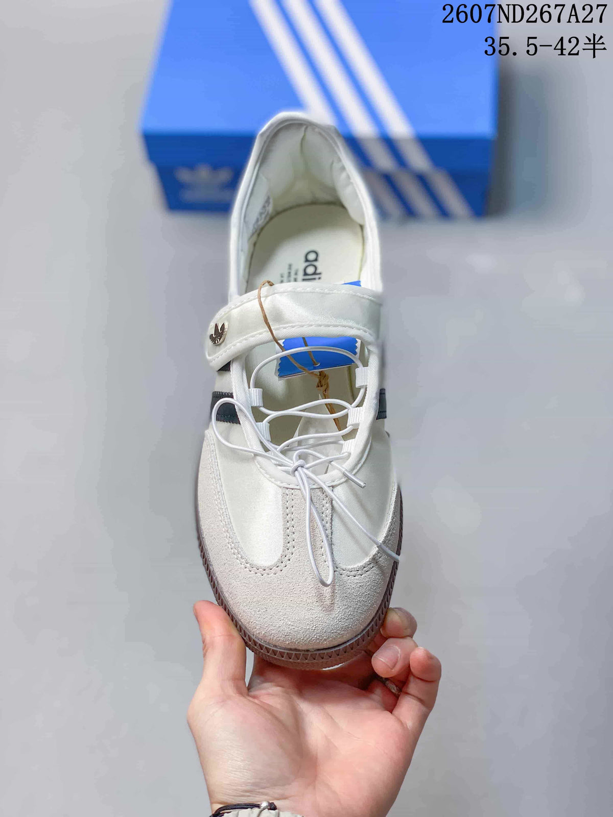 Top view of the white sneaker showing the Mary Jane-style strap, laces and textured toe panel.