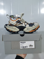 Balenciaga 2070 sneakers displayed on a shoebox; the box label shows model code 2070, color text “BEIGE/ORANGE,” and size 37.