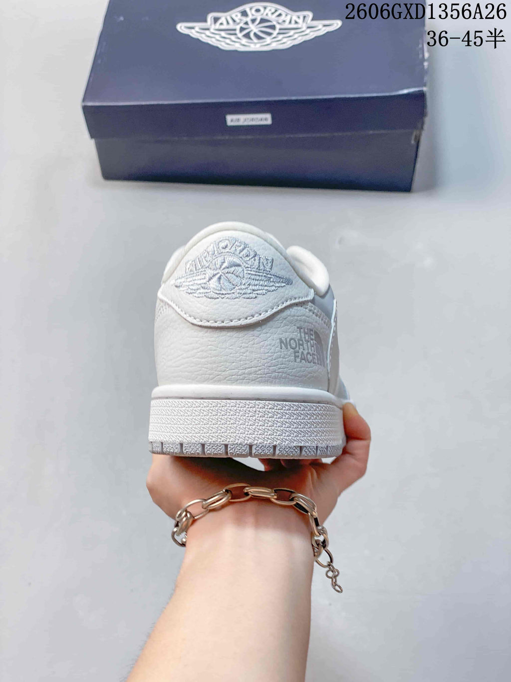 Rear view showing heel details and side branding on a white sneaker