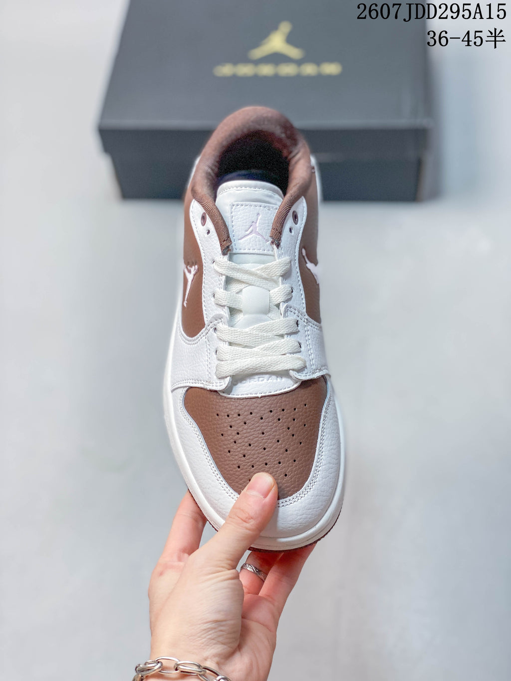 Top view showing white laces, a brown perforated toe panel, and Jordan tongue branding.