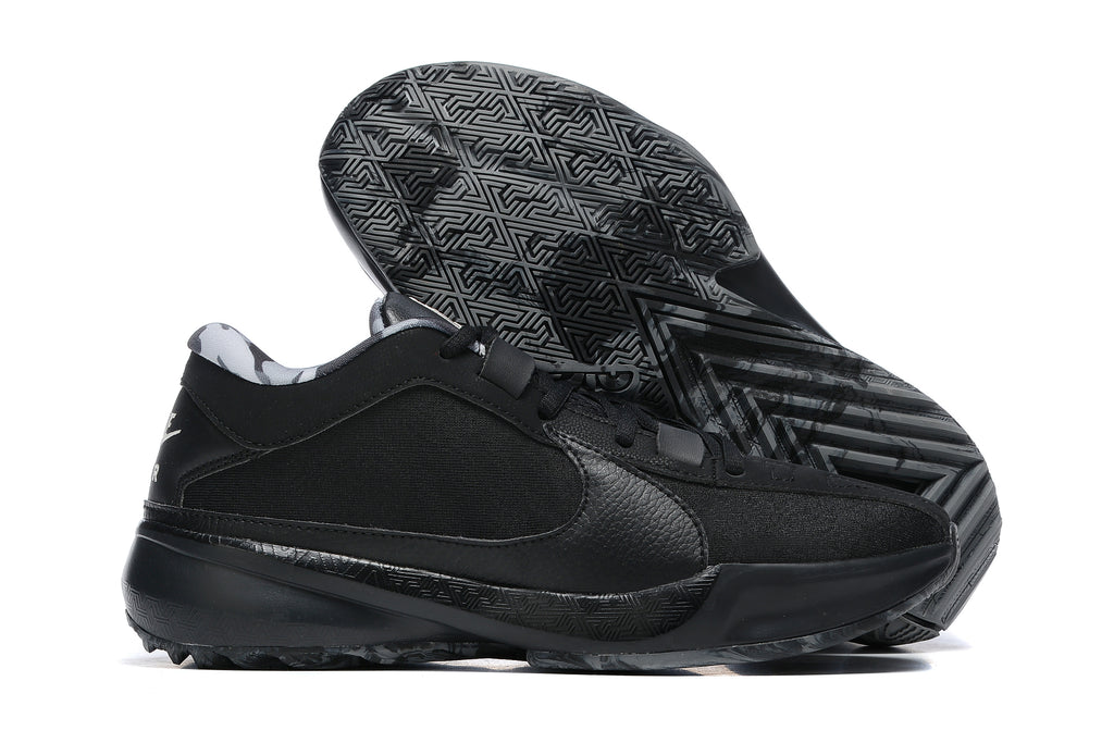 All-black low-top basketball shoes with a black and gray patterned outsole.