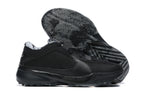 All-black low-top basketball shoes with a black and gray patterned outsole.