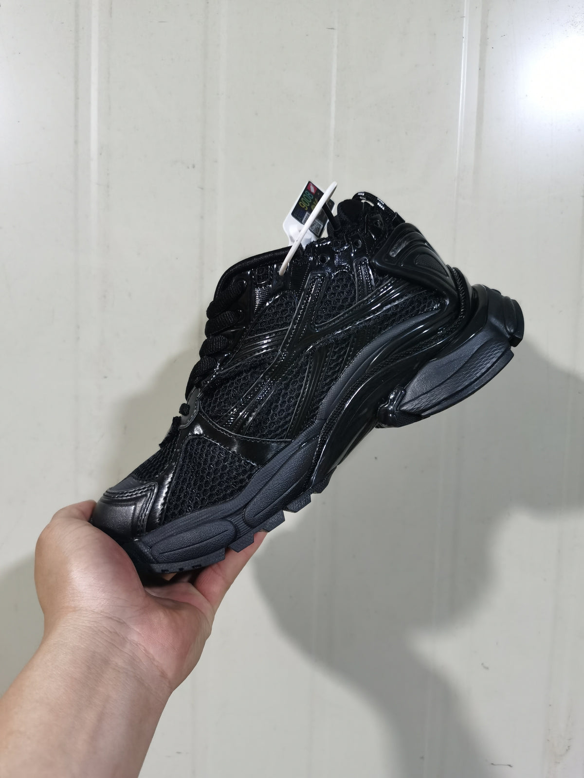 Rear-side view of the black Balenciaga Runner sneaker showing the sculpted sole and layered upper design.