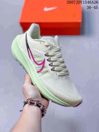 Light green and white Nike Air Zoom Pegasus 39 sneaker with magenta side branding and a pale green midsole.