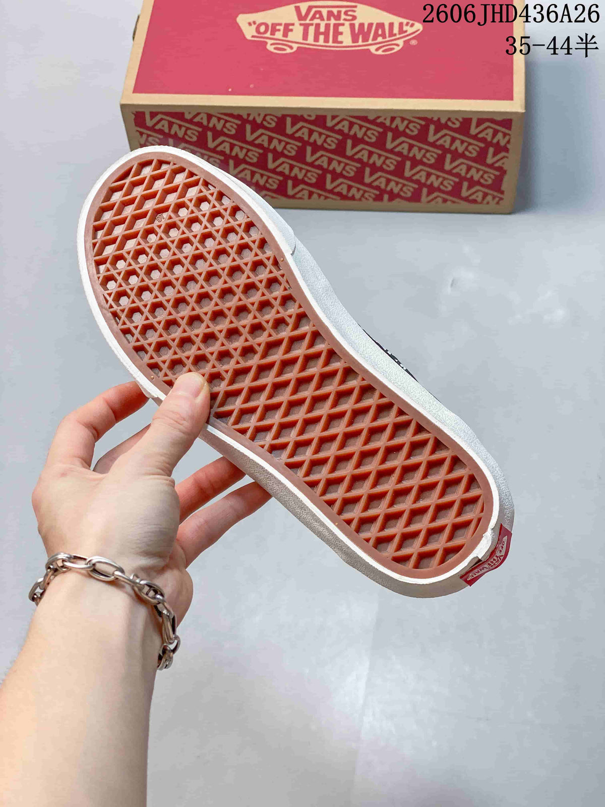 Close-up of the patterned rubber outsole and Vans shoebox.