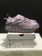 Side view of purple Nike Mind 002 sneakers with perforated uppers and sculpted soles.