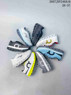 Several On Cloudstratus 3 kids running shoes arranged in a circle, showing the available pictured color combinations.