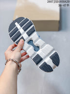Underside of the sneaker showing a segmented white outsole with dark traction sections and CloudTec branding.