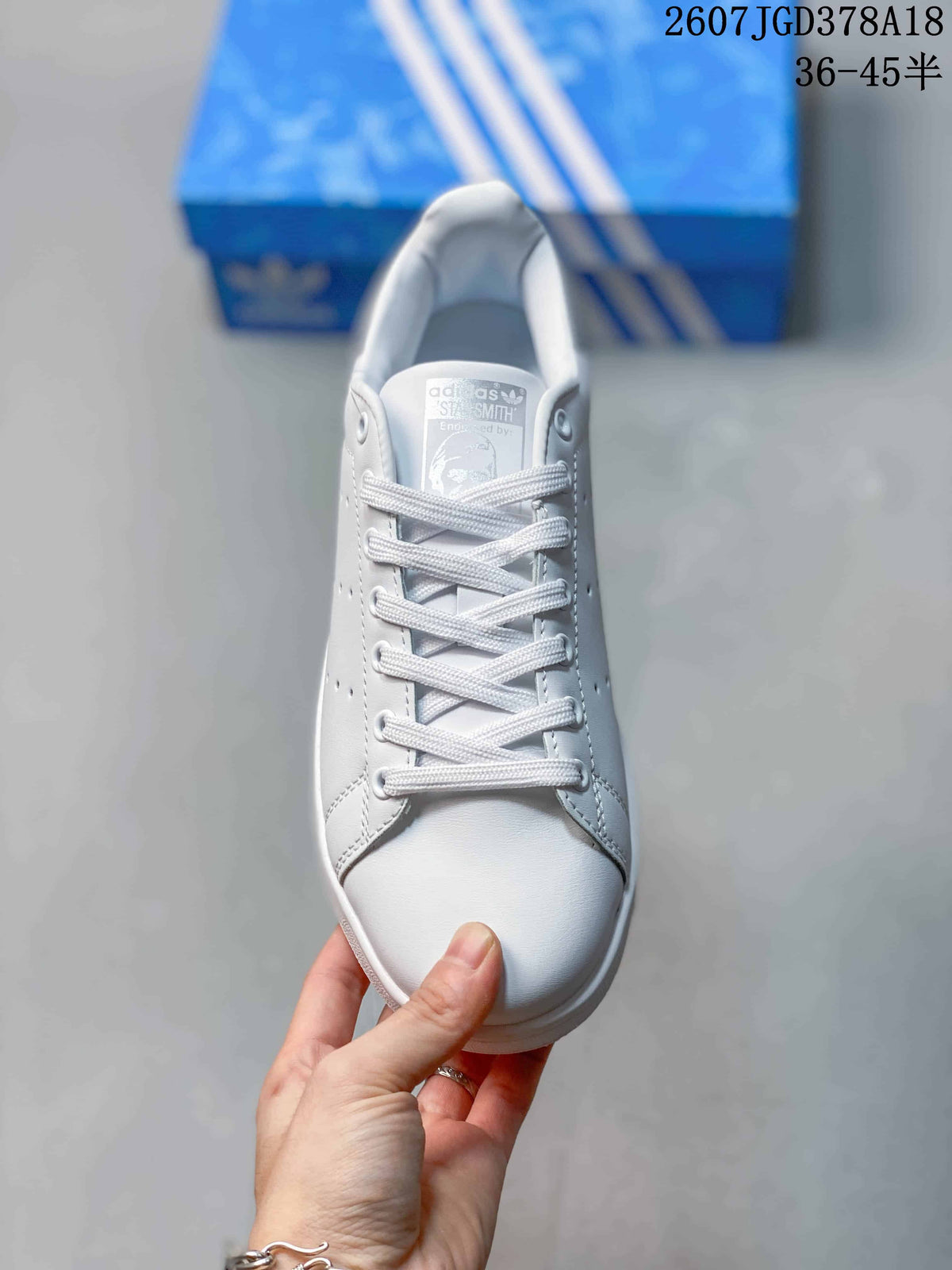 Top view showing the white laces, padded collar, and Stan Smith tongue label.