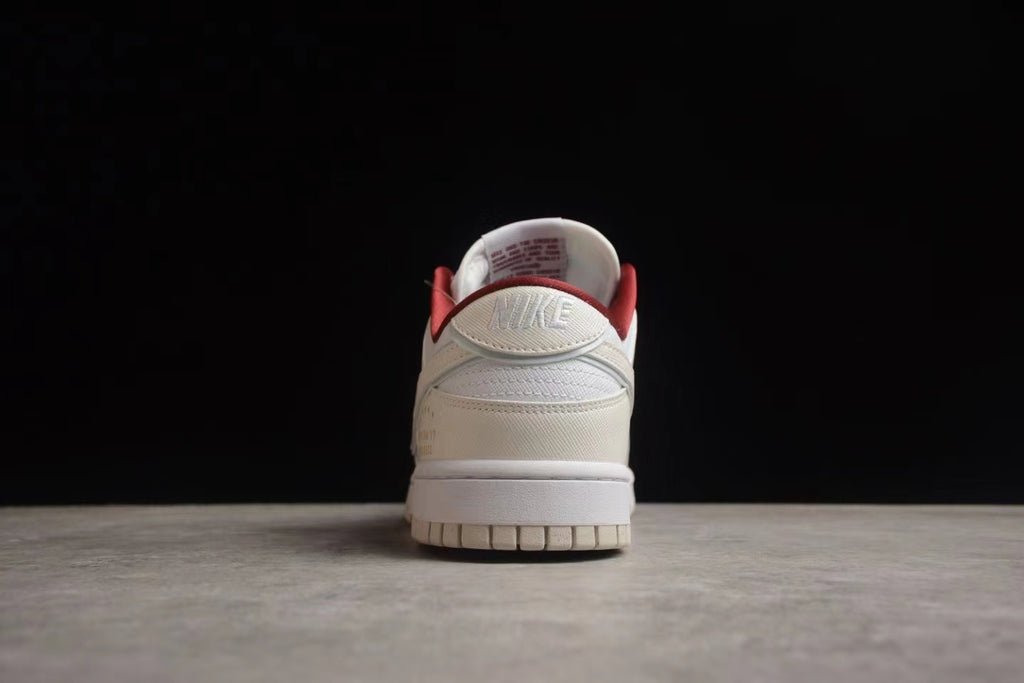 Rear view showing the layered heel construction, white midsole, and red collar lining.