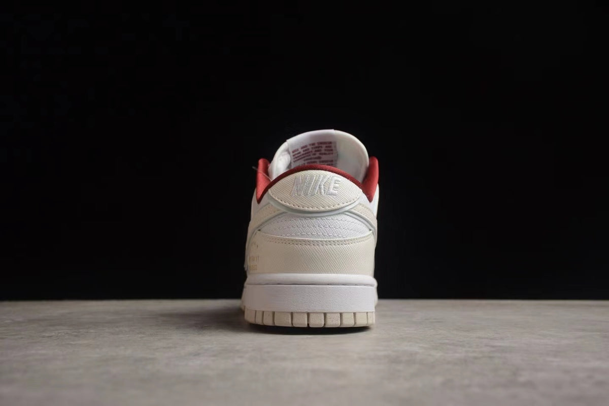 Rear view showing the layered heel construction, white midsole, and red collar lining.