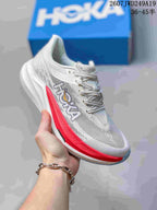 White Hoka One One MAFATE X shoe with red side and sole accents, shown against a blue shoe box.