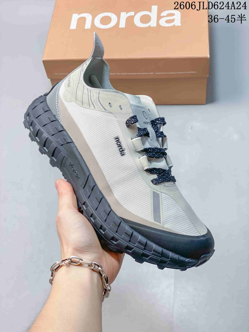 Angled side view of the Norda shoe showing the upper, heel, and thick dark outsole.
