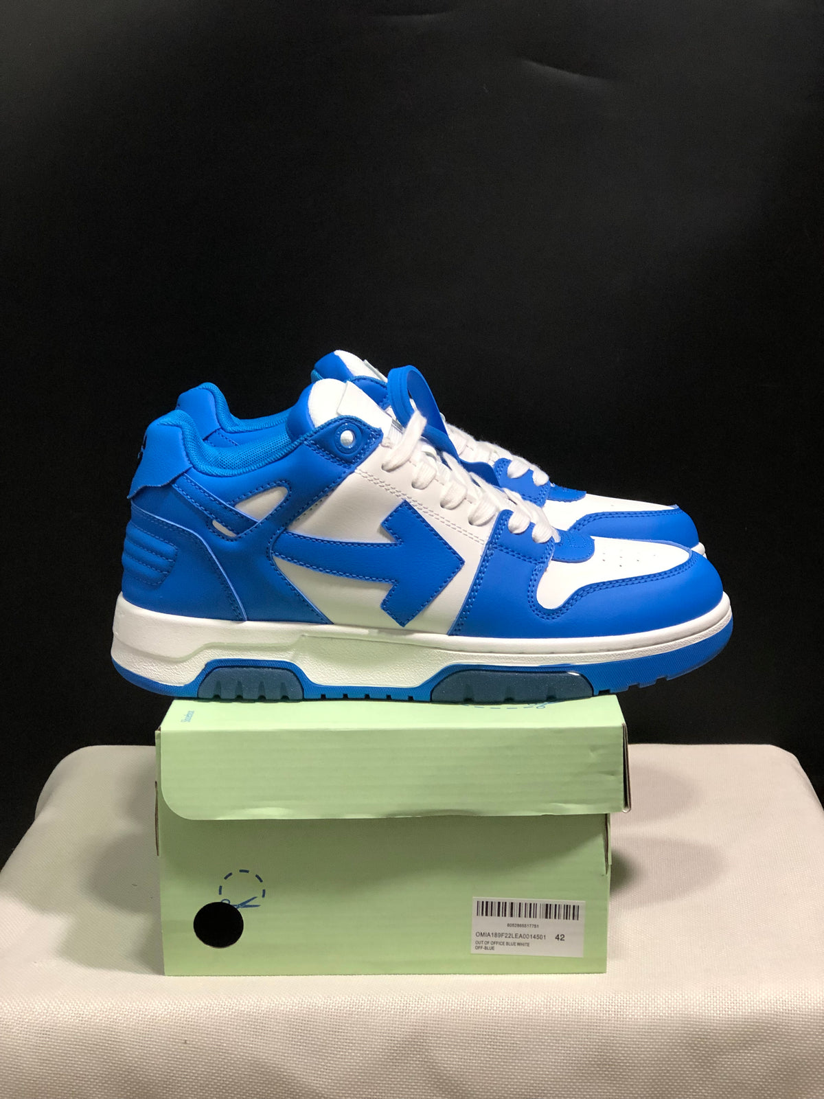 Side view of the blue and white sneakers showing the layered panels and padded collar.