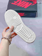 Underside of the white sneaker showing its molded outsole tread.