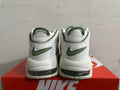 Rear view of white Nike sneakers with green heel logos and visible sole cushioning windows