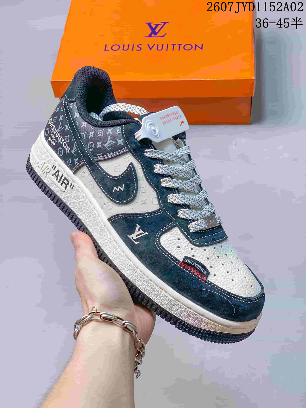 Close-up of a navy-and-white sneaker with printed panels and a contrast Swoosh
