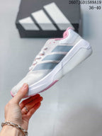 Side profile of the white trainer showing gray stripe overlays, a raised heel section and pink outsole details.