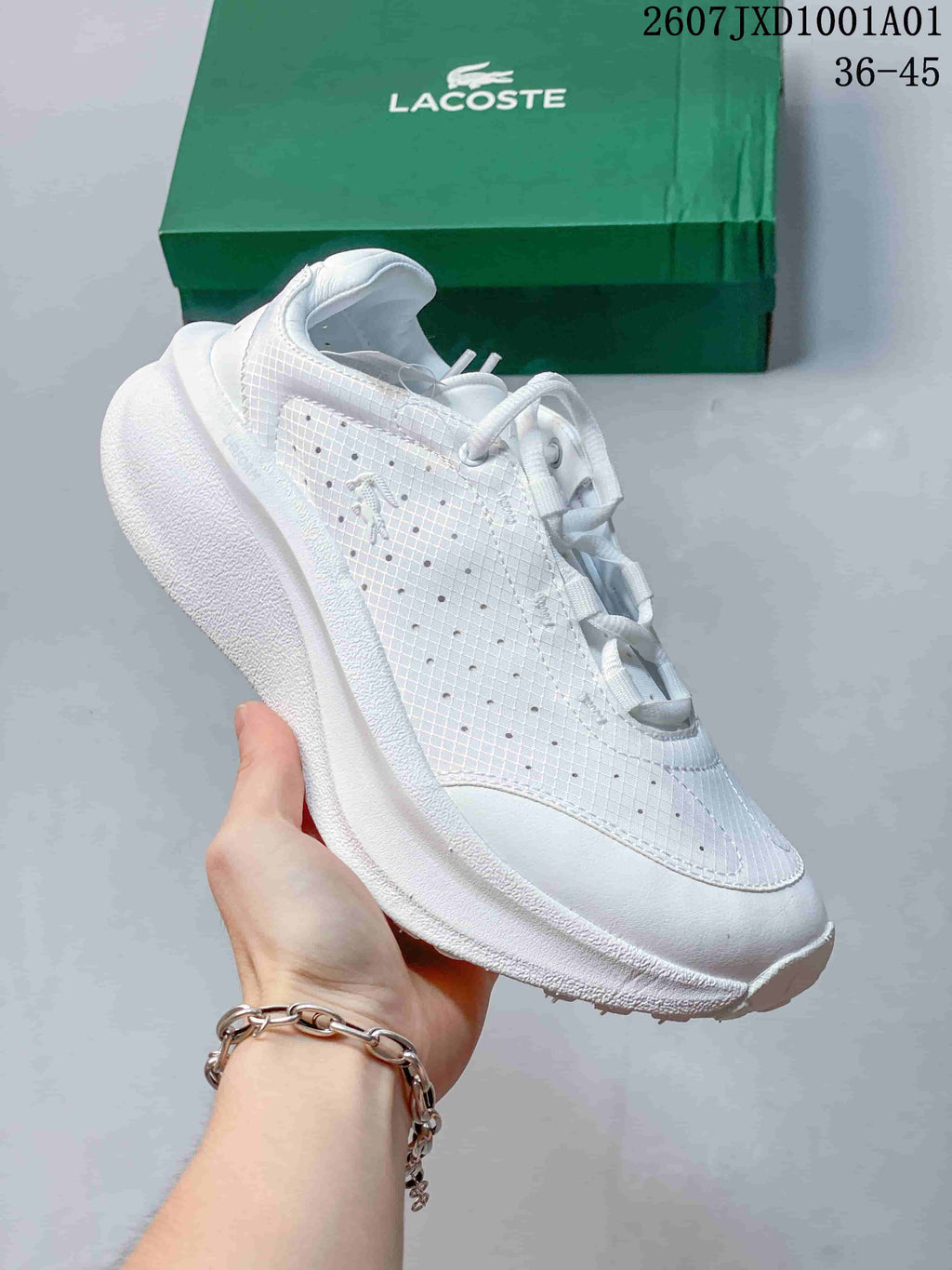 Angled side view of a white Lacoste sneaker with a low-top profile