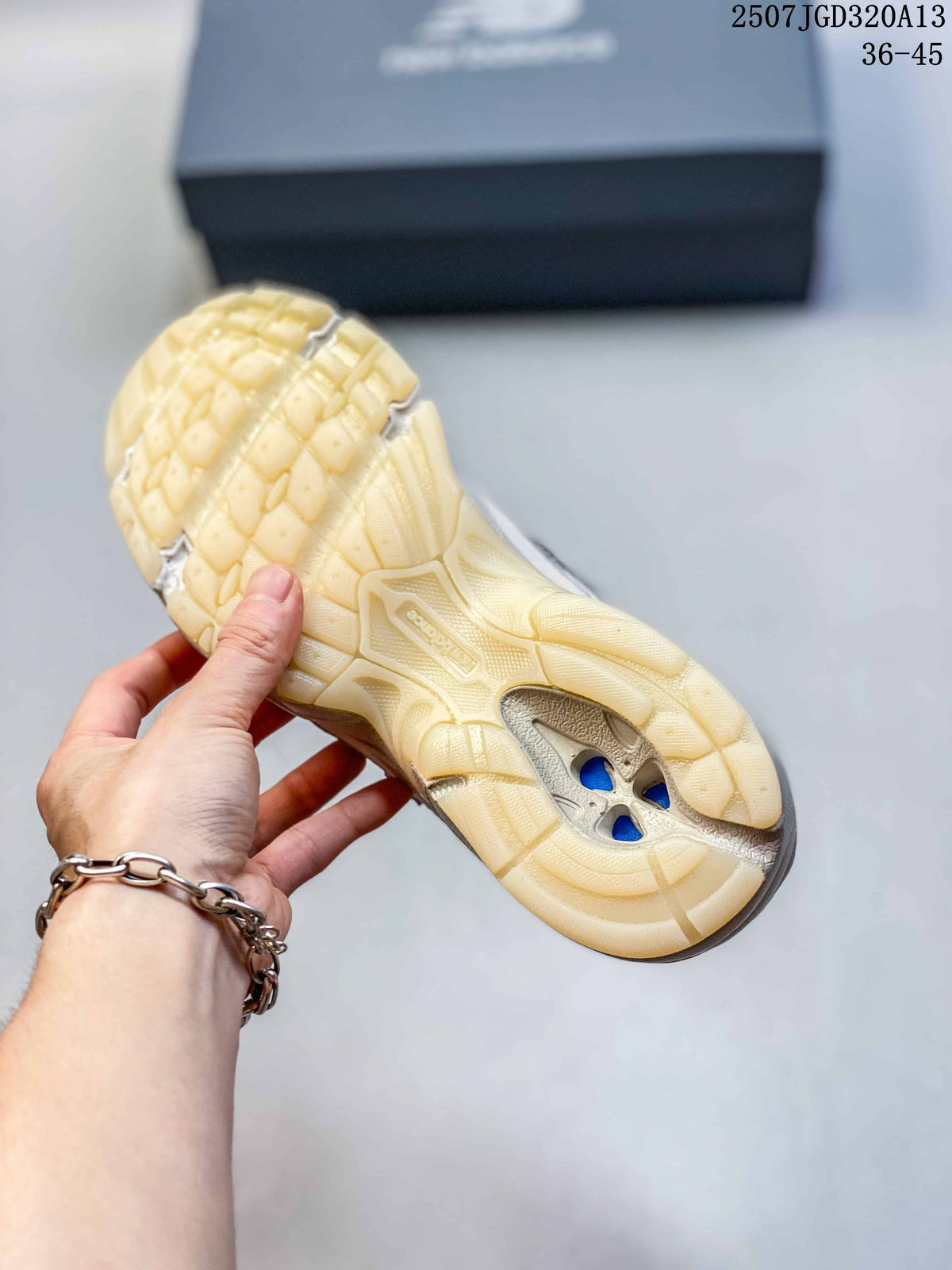 Close-up of the cream sneaker outsole showing a chunky textured tread and cutout details.